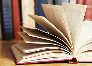 Open book with bookshelf behind