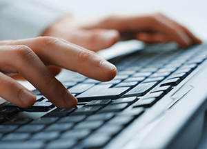 Person typing on keyboard