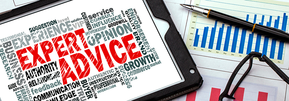 Computer tablet, pen and spectacles on top of printed graphs